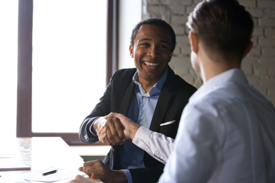 Insurance Marketplace in Rochester Cares - Two people shaking hands