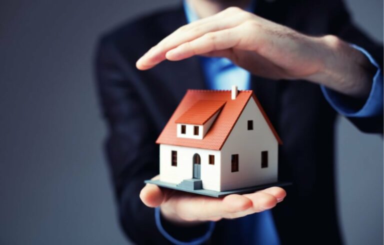 man holding and protecting a house