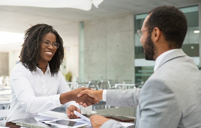 People shaking hands after getting insurance policy